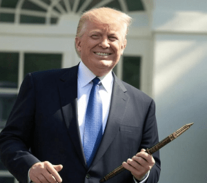 President Trump smiling and holding a pen outside the White House, symbolizing his first day back in office and new executive orders.