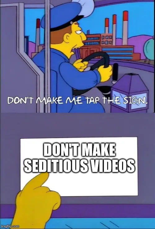 Meme showing a Simpsons character tapping a sign that reads “Don’t make seditious videos,” used as commentary on the recent military orders video controversy.