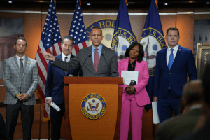 Hakeem Jeffries at podium with U.S. House and American flags behind him