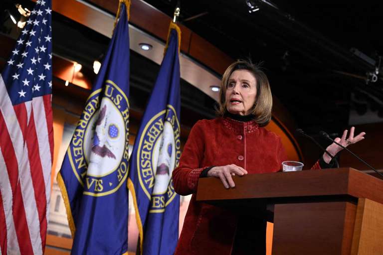 Former House Speaker Nancy Pelosi waves from the House Chamber after announcing her retirement.
