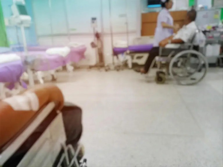 Patients wait in a crowded Canadian hospital hallway amid prolonged medical delays linked to thousands of deaths before treatment.